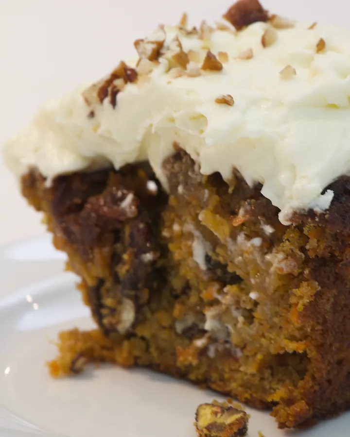 Carrot cake with cream cheese icing and chopped pecan nuts